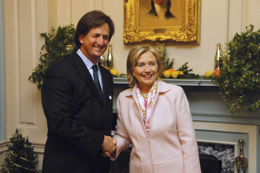 U.S. Secretary of State Hillary Clinton greets our publisher, Bryan Welch.